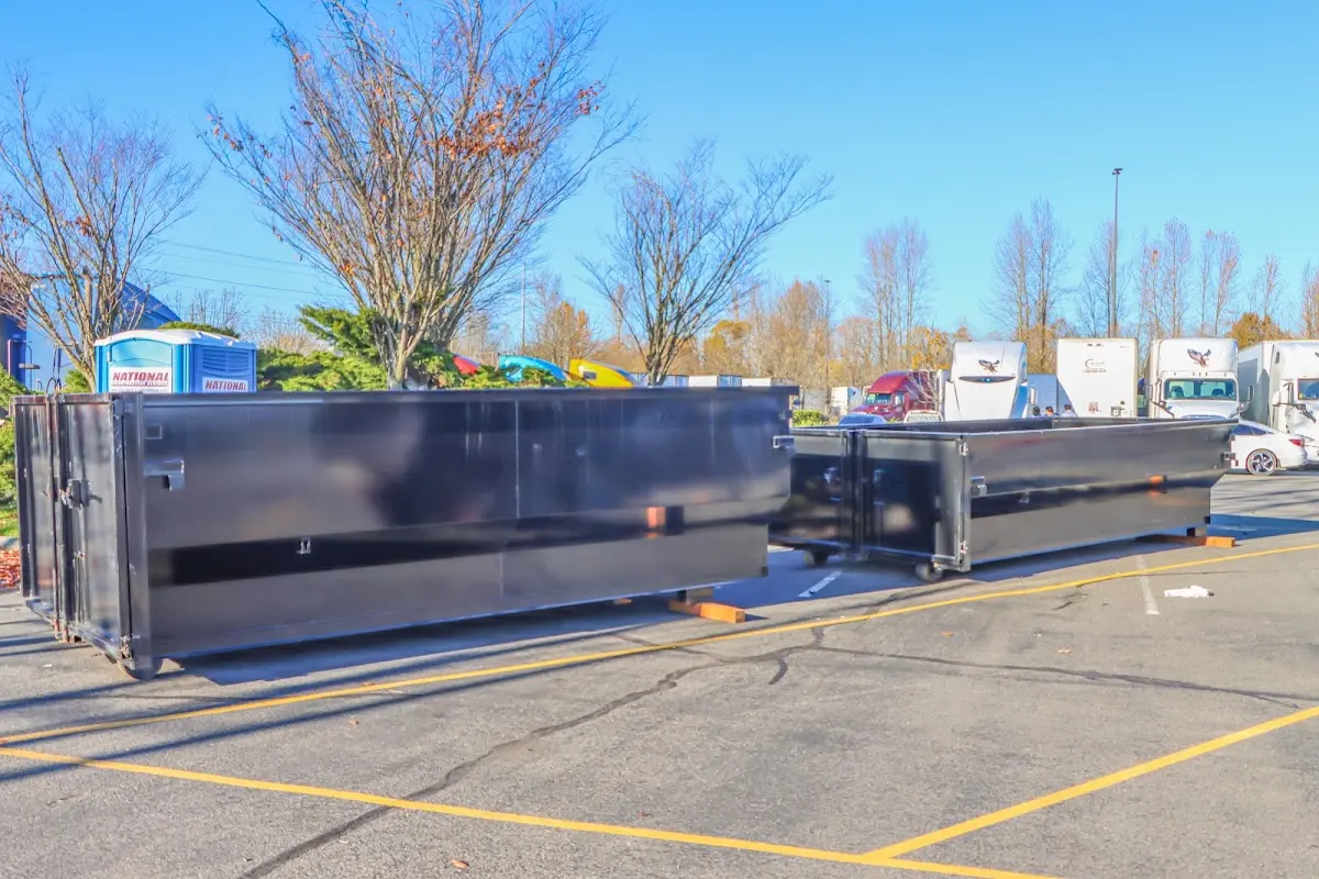 Professional dumpster rental service with roll-off container on residential driveway in Orleans